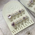 Short cream nails with pink heart gems and pearl chains on rose embossed card - Large (L)