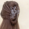 Silver hollow bear metal hair claw clip worn on a brown braided bun hairstyle - Silver Bear Rhinestone Style