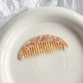 Portable acetate hair comb with pink marble pattern on white ceramic plate - Yellow Pink