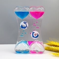 Heart-shaped liquid hourglass motion timer with blue and pink drops and dolphin charms - SY01 Heart Single Dolphin