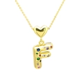 Macro detail of gold letter F pendant with colorful zircons and heart connection - Letter-F