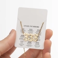 Golden stainless steel angel number 333 necklace displayed on themed card - Cutout 333 / Gold