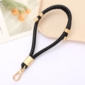Detail of black PU leather wrist strap with gold metal lobster clasp and reinforced ring - Black