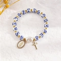 Detail of blue and white ceramic beads bracelet with Virgin Mary and cross charms - Religious Icon and Cross Style (6046)