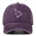 Close-up of silly goose embroidery on washed dark purple cotton baseball cap fabric - Purple