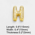 Macro shot of gold-plated letter H charm with sparkling cubic zirconia, size 15x10x5mm - Letter H