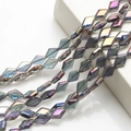 Close-up of diamond-shaped crystal glass beads with dark iridescent electroplated finish - Amethyst