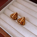 Detailed view of leopard print triangle earrings with gold bar in a velvet box - Gold Triangle Leopard Stud Earrings