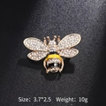 Macro shot of gold bee brooch with inlaid rhinestones and yellow enamel on black background - Gold Enamel Rhinestone Bee