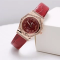 Macro shot of rose gold octagonal case with zircon inlay and red sunray dial watch - Red