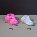 Detail view of pink silicone dog shoe mold with white plaster storage box outcome - Polar Bear Mold