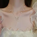 Close-up of elegant gold butterfly pendant necklace with pearls on a model's neck - 23# Necklace-Gold