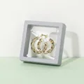 Golden twisted hoop earrings displayed in a square gray PE film suspension storage box - Gray
