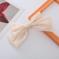 Elegant cream satin oversized bow hair clip with a pearlescent finish and layered design - Creamy White Pearl Luster Bow Spring Clip