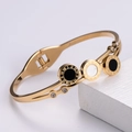 Brazalete de oro rosa con números romanos, dijes de concha negra y detalles de circón - Pulsera de Concha Blanca y Negra / Dorado