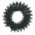 Macro shot of black metallic acupressure massage ring with textured spike design - Black