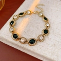Detalle de una pulsera dorada vintage con piedras ovales negras y cristales brillantes - Pulsera (Dorado)