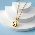 Golden 3D bubble letter H pendant necklace on a minimalist geometric display stand - Letter N(N)
