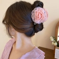 Rear view of a model wearing a pink organza flower hair claw with elegant pearl details - Pink Tulle Layered Rose (Claw Clip)