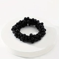 Minimalist elastic hair tie featuring polished black beads on a white display stand - Black