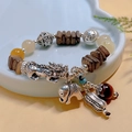Vintage agate and bone bracelet with silver Pixiu and elephant charms in a ceramic dish - Coconut Shell: Pixiu Crystal Bracelet