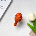 Detailed view of 3D roasted chicken leg phone grip holder on a white textured background - Transparent Stand - Chicken Leg
