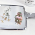 Mini acetate hair claw clip with pink and green marble texture on a mirror base - Emerald Green
