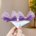 Pair of purple mesh bow hair clips for girls displayed on a white product card - Purple
