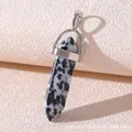 Macro shot of Dalmatian Jasper bullet point pendant with polished silver metal bail - Black and White Spots