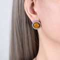 Retro round earrings with brown tiger eye stone and silver twisted frame on a model - Steel Color Tiger's Eye Earrings
