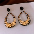 Macro detail of crescent resin earrings featuring gold foil flakes and black beads - Vintage Gold Foil Resin Crescent Pendant Style