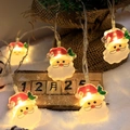 LED Christmas light string with Santa Claus figurines emitting a warm yellow glow - Bearded Old Man Gnome