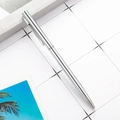 Sleek silver metal ballpoint pen with polished finish on a white grid desk - Cross Style Electroplated Silver