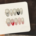 Handmade press-on nails with red and black polka dots, 3D bows and pearl accents - Large (L) / Medium Oval (3451)