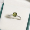Silver ring with square green gemstone and side diamonds displayed in a white jewelry box - Square Cut Olive Green Gemstone Style (白金色12)