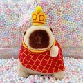 Capybara plush keychain wearing a yellow crown and red plaid cloak on pastel foam balls - Monk Light Brown + Bead Chain