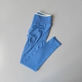 Flat lay of sky blue high-waisted seamless yoga pants with white trim waistband detail - Electric Blue