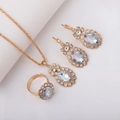 Elegant gold bridal jewelry set featuring oval crystals with halo pendant ring earrings - Three-Piece Set / Oval-White