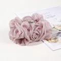 Macro detail of large dusty rose chiffon hair claw with elegant ruffled texture - Pink Purple