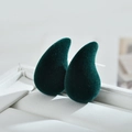Macro shot of dark green flocked teardrop earrings displayed in a white jewelry box - Green