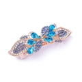 Macro detail of alloy hair clip with blue rhinestones on a gold spring base - Style D / Blue
