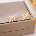 Star shaped gold stud earrings with elegant white pearls on a grey jewelry box surface - 42# Pearl Eight-pointed Star Earrings