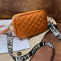 Orange quilted crossbody camera bag with rhombus stitching and wide Love woven strap - Brown