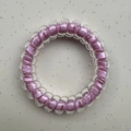 Purple spiral telephone wire hair tie with a clear plastic outer shell and elastic core - Purple Core