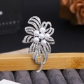 Elegant floral silver brooch with sparkling rhinestones and pearls on a wooden display stand - White Pearl Flower