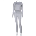 Detail of gray long-sleeved cropped top and high-waisted yoga leggings set on mannequin - S / Gray