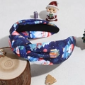 Close-up of a blue knotted headband featuring Santa Claus and Christmas gift prints - Blue Santa Claus