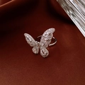 Detailed macro view of a silver butterfly ring with sparkling zircon stones on satin fabric - Silver Pave Butterfly Open Style (14#)