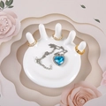 White palm jewelry tray holding gold rings and heart pendant on pink floral backdrop - Five-Finger White