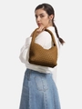 Handwoven caramel leather hobo bag with signature knot handle shown on shoulder - Shoulder Bag Set / Brown